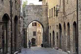 Old Town San Gimignano, Tuscany, Italy, Europe, A quiet, narrow alleyway in an old town with stone