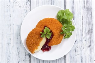 Fresh made Fried Camembert (selective focus) on wooden background