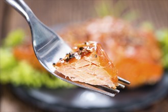 Piece of Smoked Salmon on a fork (detailed close-up shot)