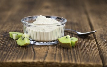 Fresh made Kiwi powder (slective focus, close-up shot) on an old wooden table