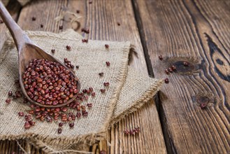 Heap of dried Red Beans (close-up shot) on wooden background