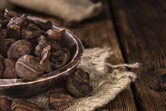Dried Cola Nuts (whole ones) on vintage wooden background