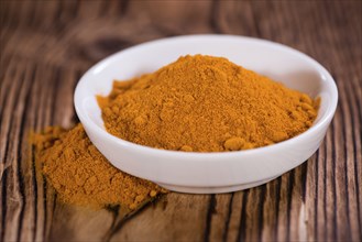 Heap of Turmeric (selective focus) on an old wooden table