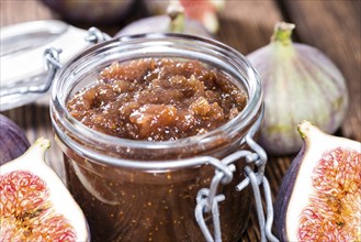 Portion of fresh homemade Fig Jam on wooden background