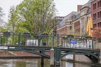 Urban scene with a bridge over a canal, surrounded by modern and old buildings, The Hague,