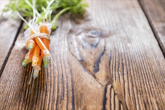 Carrot Injection (with green) on vintage wooden background