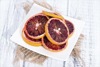 Fresh piece of juicy Blood Orange (close-up shot)