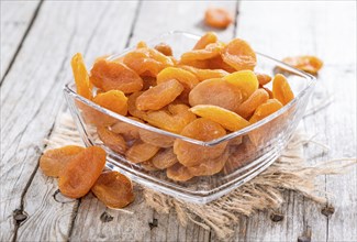 Fried Apricots (close-up studio shot) on vintage weathered background