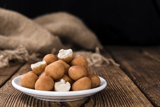 Marzipan Potatoes (German cuisine) on rustic wooden background