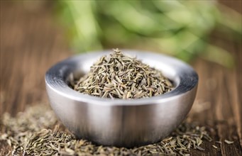 Portion of dried Thyme (selective focus) on an old wooden table