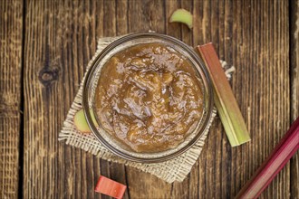 Rhubarb Jam on an old wooden table as detailed close up shot (selective focus)