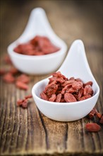 Fresh made Dried Goji Berries on a vintage background (close-up shot)