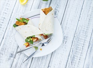 Chicken Wrap (detailed close-up shot, selective focus) on wooden background