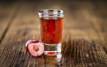 Homemade Cherry Liqueur on vintage background selective focus, close-up shot