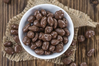 Chocolate Raisins (selective focus) on an old wooden background