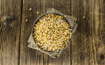 Wooden table with a portion of Corn (selective focus, close-up shot)