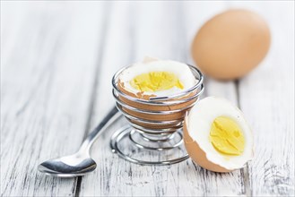 Some boiled Eggs (close-up shot, selective focus) on an old wooden table