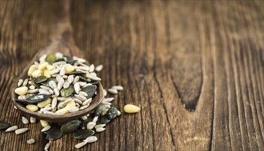 Portion of mixed Seeds (close-up shot, selective focus) on wooden background