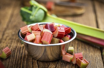 Chopped Rhubarb on an old wooden table (close up shot, selective focus)