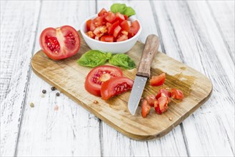 Diced Tomatoes on a vintage background as detailed close-up shot (selective focus)