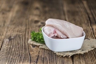 Wooden table with chicken cutlet (detailed close-up shot)