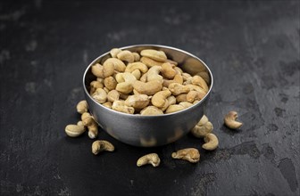 Some roasted Cashew Nuts as detailed close up shot (selective focus)
