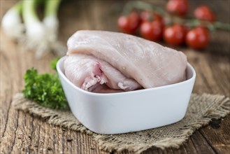 Old wooden table with raw Chicken Cutlet (detailed close-up shot)