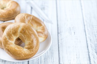 Plain Bagel (selective focus) on vintage background (close-up shot)