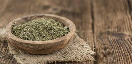 Portion of Stevia Leaves (dried, close-up shot) on wooden background