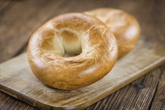 Plain Bagel (selective focus) on vintage background (close-up shot)