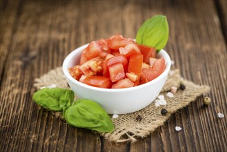 Diced Tomatoes on a vintage background as detailed close-up shot (selective focus)