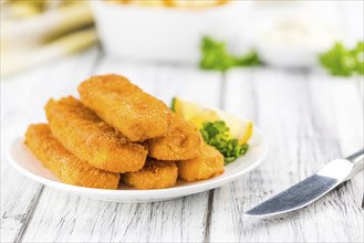 Fried Fish Fingers (selective focus) on wooden background (selective focus)