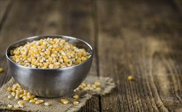 Portion of Corn (detailed close-up shot) on wooden background (selective focus)