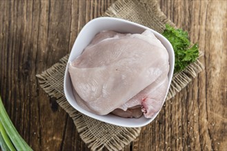 Wooden table with chicken cutlet (detailed close-up shot)