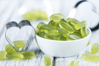 Gummy Candy with lime taste (selective focus) on wooden background