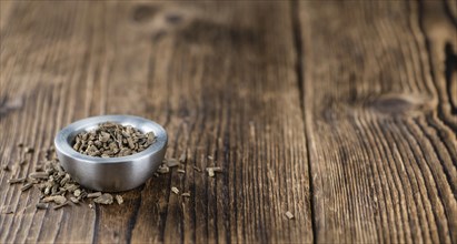 Valerian roots (dried, detailed close-up shot) on wooden background