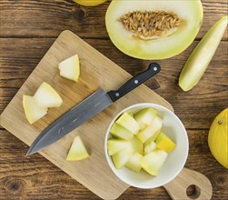 Fresh made Yellow Honeydew Melon on a vintage background (close-up shot)