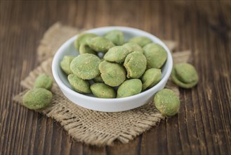 Wasabi Peanuts on a vintage background as detailed close-up shot (selective focus)