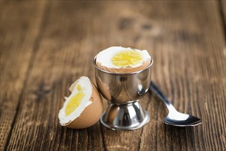 Some boiled Eggs (close-up shot, selective focus) on an old wooden table