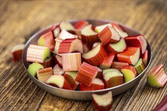 Chopped Rhubarb on an old wooden table (close up shot, selective focus)