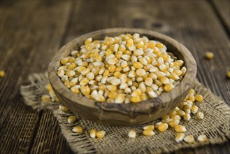 Wooden table with a portion of Corn (selective focus, close-up shot)