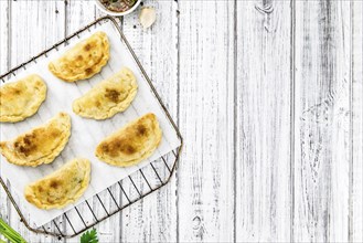 Portion of fresh homemade Empanadas as detailed close-up shot, selective focus