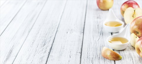 Wooden table with Applesauce (close-up shot, selective focus)