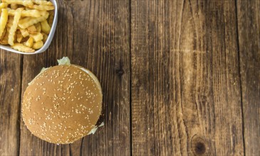 Wooden table with a homemade Falafel Burger (selective focus)