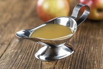 Wooden table with Applesauce (close-up shot, selective focus)