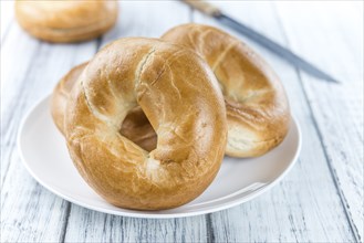 Fresh baked Bagels (selective focus) on an old wooden table