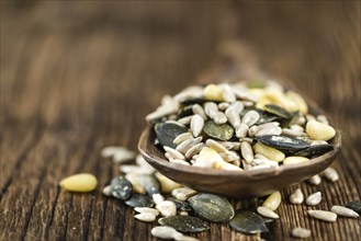 Mixed Seeds (close-up shot, selective focus) on vintage wooden background