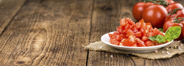 Diced Tomatoes on a vintage background as detailed close-up shot (selective focus)