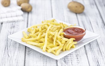 Portion of fresh made crispy French Fries (selective focus, close-up shot)