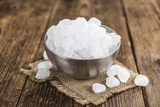 Portion of Rock Sugar (selective focus) on a wooden table